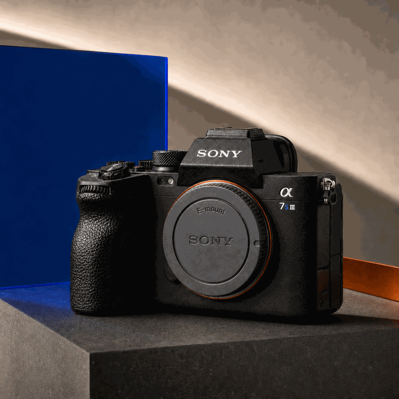 Sony Alpha 7S III body with accurate front badge and grey body cap on a blue, orange and charcoal FRAMEHAUS set